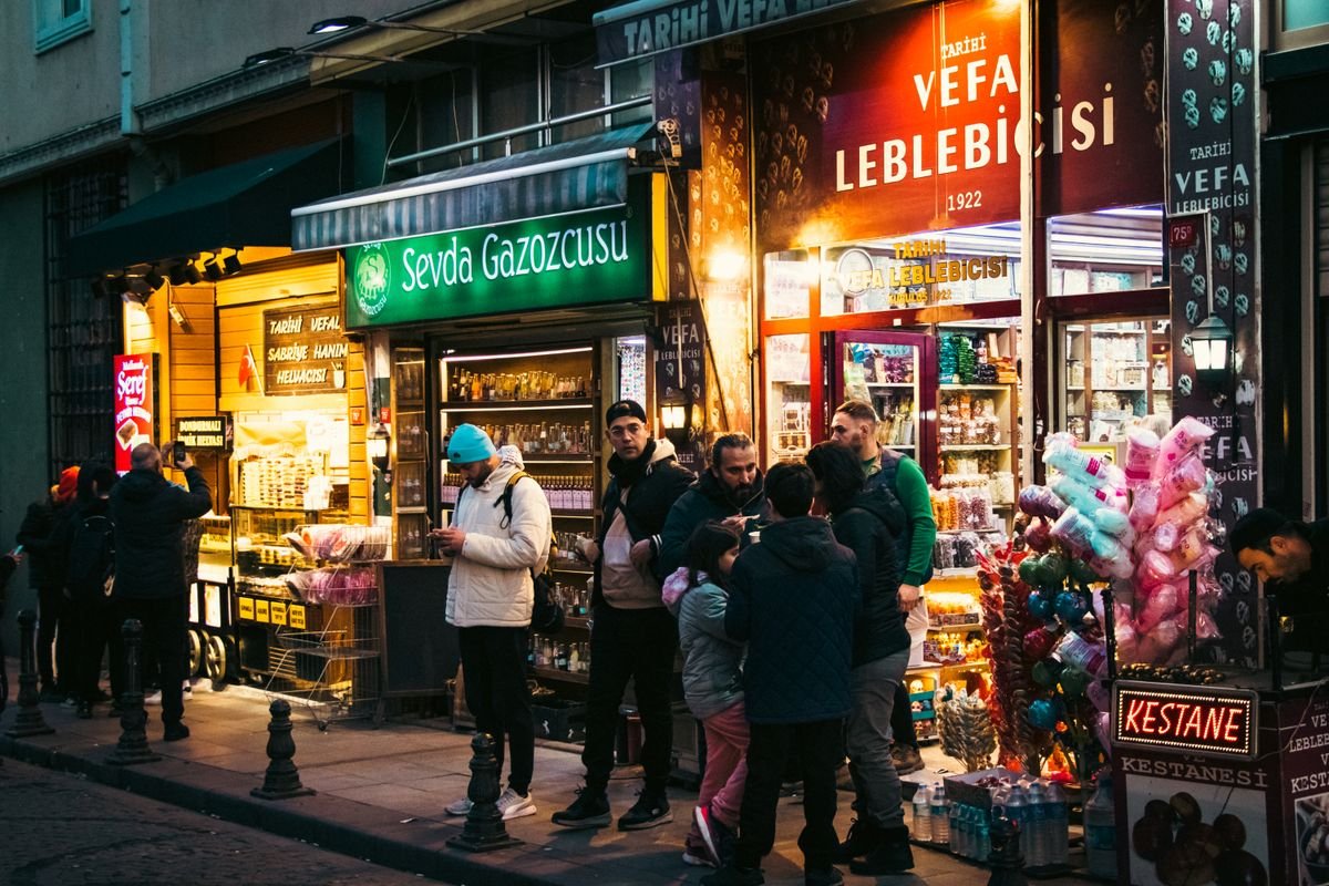 Shoppers outside small stores on a street in Turkey