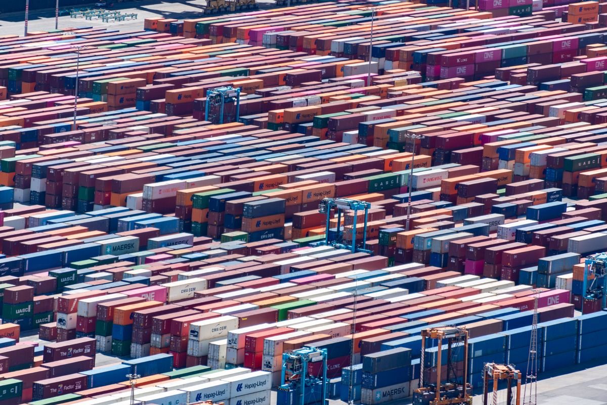 Stacked shipping containers at a port seen from above